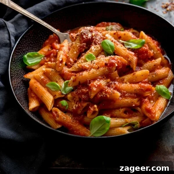 Roasted Veggie Pasta with Garlic and Parmesan 13 A black bowl filled with penne arrabiata.