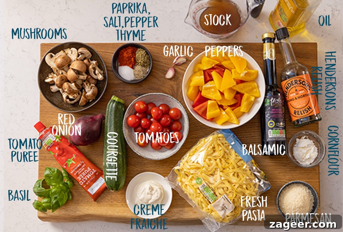 Roasted Veggie Pasta with Garlic and Parmesan 4 Ingredients for roasted vegetable pasta on a wooden board on a white background.