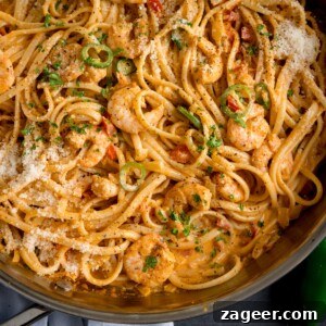 Creamy Cajun Shrimp Pasta Recipe — Quick Spicy Dinner 7 square overhead image of a pan of prawn linguine in a creamy buffalo sauce.
