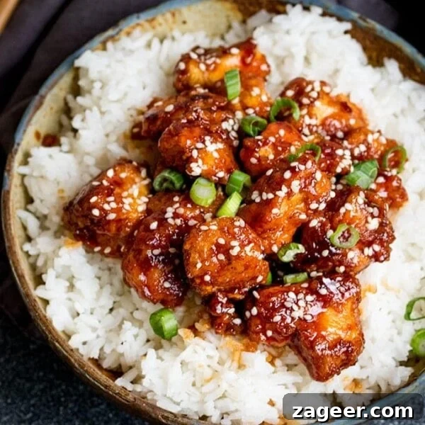 Spicy Honey-Glazed Chicken Recipe 12 Crispy Sesame Chicken on a bed of rice in a stone bowl