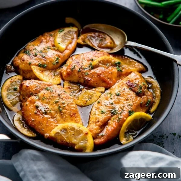 Spicy Honey-Glazed Chicken Recipe 9 Square image of a dark pan filled with honey lemon chicken.
