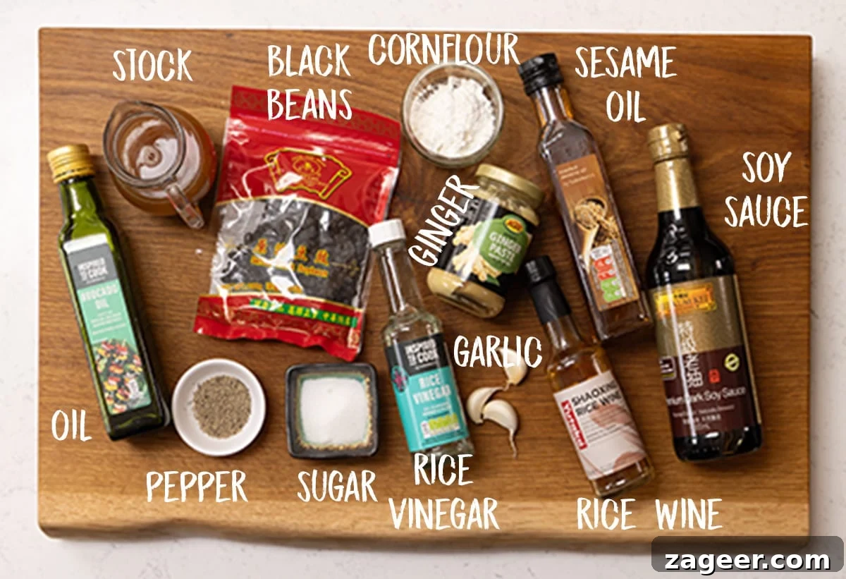 Authentic Black Bean Sauce Recipe for Stir-Fries and Marinades 4 Ingredients for homemade black bean sauce on a wooden board.