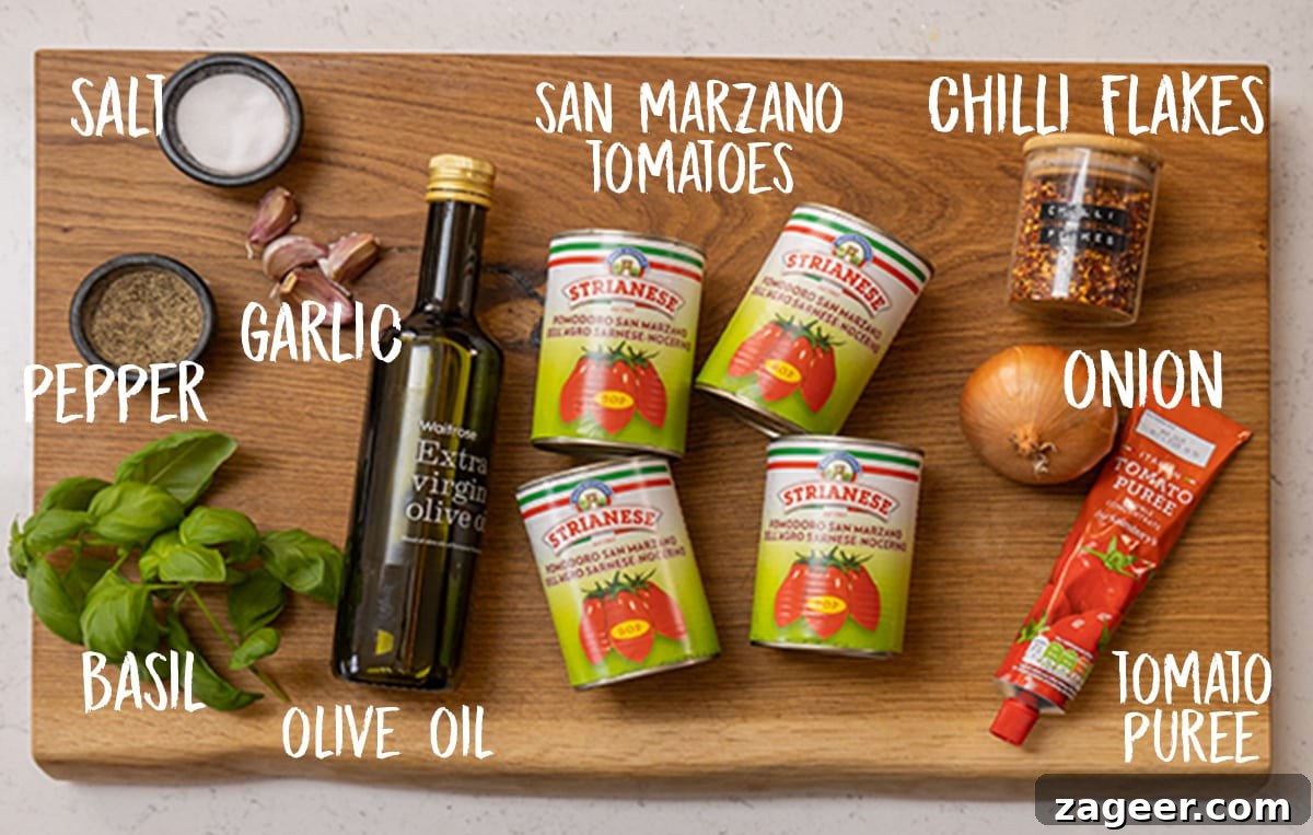 Spicy Penne Arrabbiata Recipe with Garlic and Tomato Sauce 3 Ingredients for Arrabbiata sauce on a wooden board.