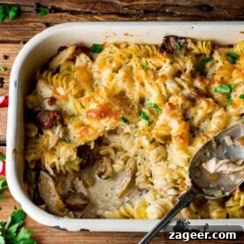 square image of chicken alfredo pasta bake with a scoop removed