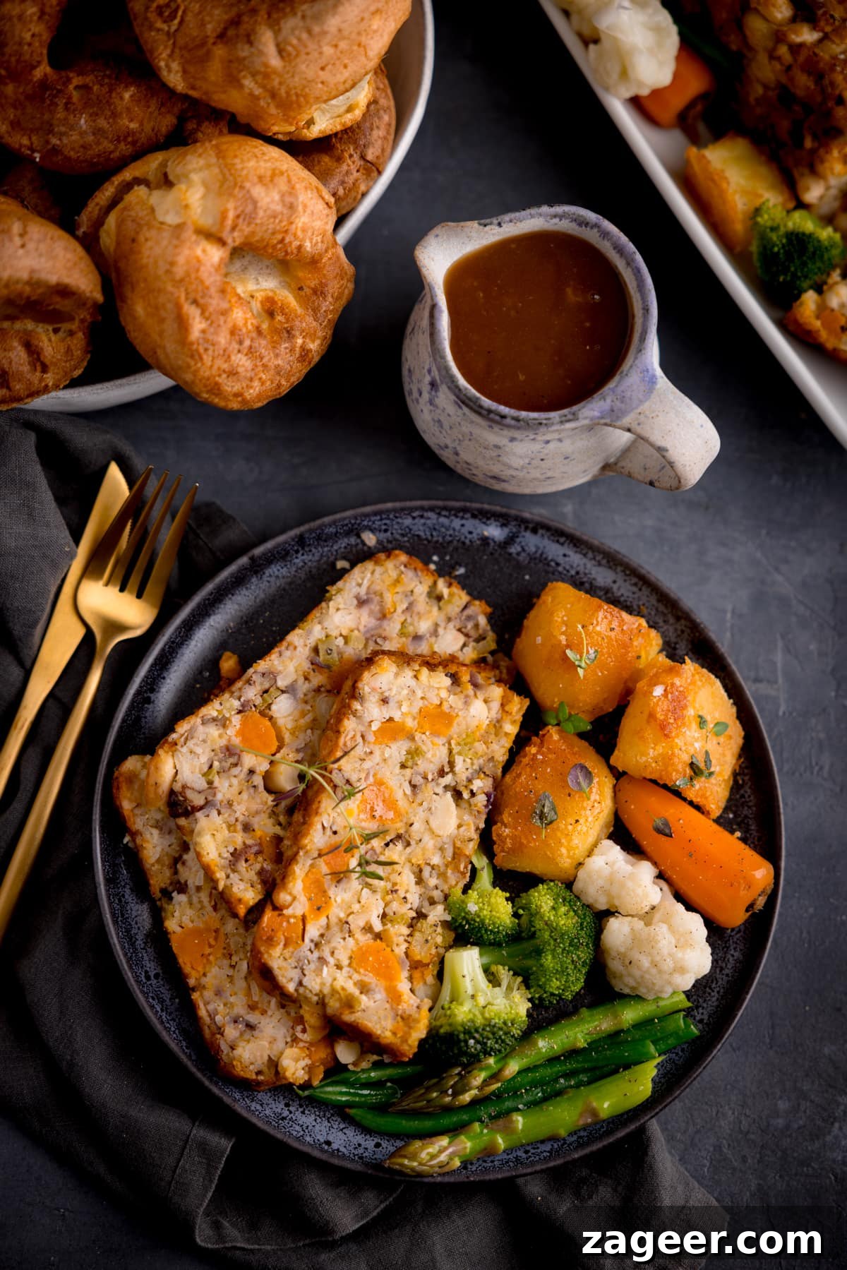 Savory Vegetarian Nut Roast Recipe for Holiday Dinners 2 Three slices of nut roast with roast vegetables and gravy