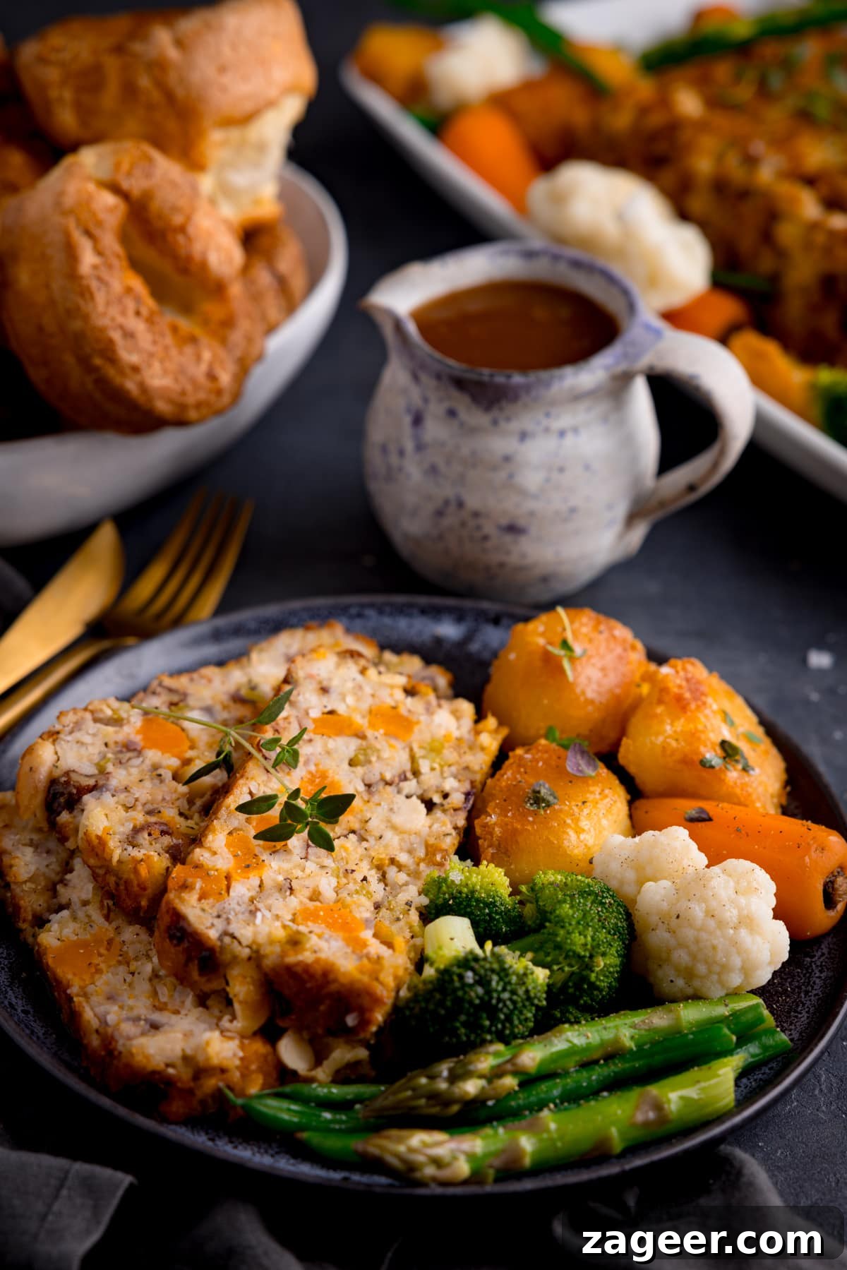 Savory Vegetarian Nut Roast Recipe for Holiday Dinners 6 Three slices of nut roast served with roast vegetables and gravy