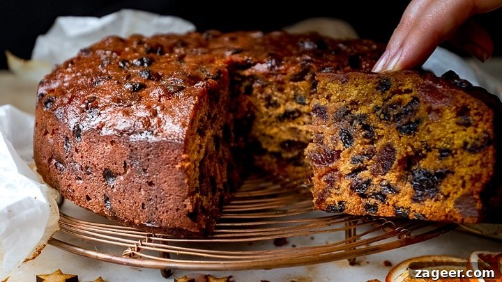 Christmas Cake Decorating Ideas for a Festive Finish 10 Slice being taken out of Christmas cake