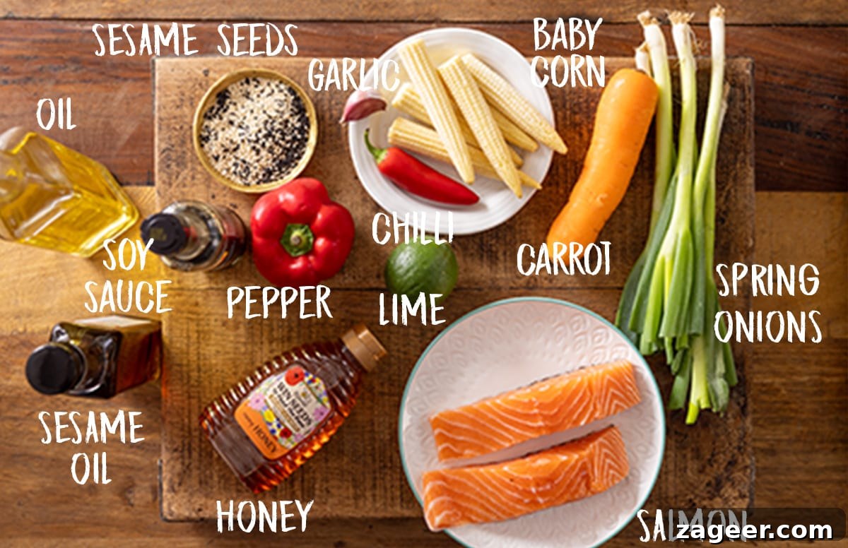 Salmon en Papillote: Steamed Baked Salmon Wrapped in Parchment 3 Overhead photo of labelled salmon en papillote ingredients on a wooden board.