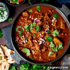 Low-Fat Slow-Cooked Spicy Beef Curry Recipe 8 Slow-cooked spicy beef curry in a dish on a dark background