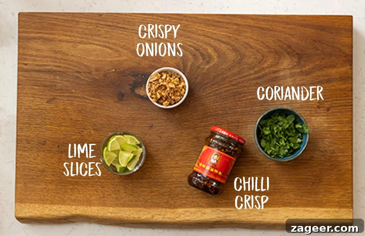 30-Minute Chicken Laksa Recipe: Flavorful Coconut Noodle Soup 6 The toppings to go onto a chicken laksa soup all sat on a wooden chopping board