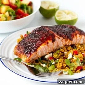 Spiced caramelised salmon served on a bed of savoury rice with feta and veggies. Colourful, healthy and delicious!