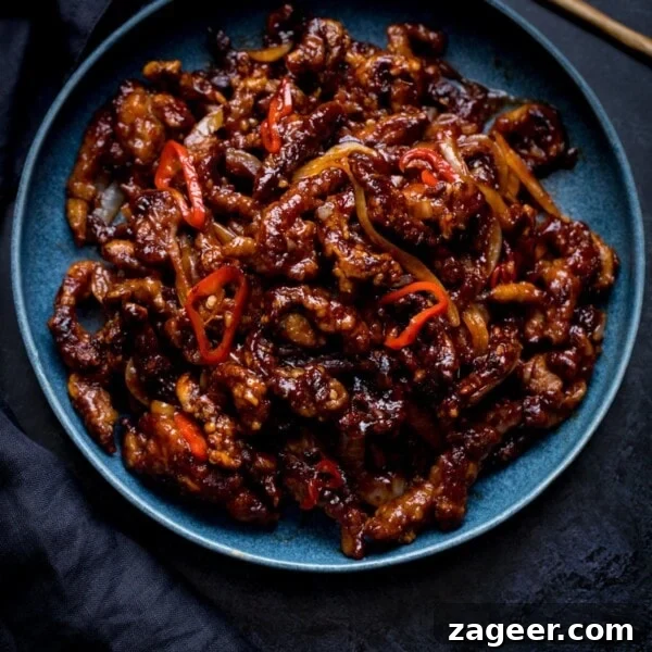 Crispy Chilli Beef Recipe with Sticky Sweet-Spicy Sauce 12 Square image of crispy chilli beef in a blue bowl