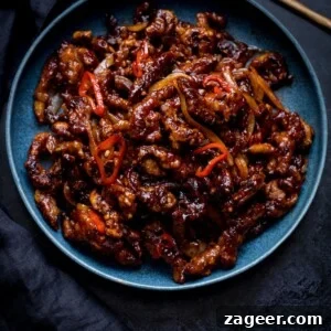 Crispy Chilli Beef Recipe with Sticky Sweet-Spicy Sauce 13 Square image of crispy chilli beef in a blue bowl