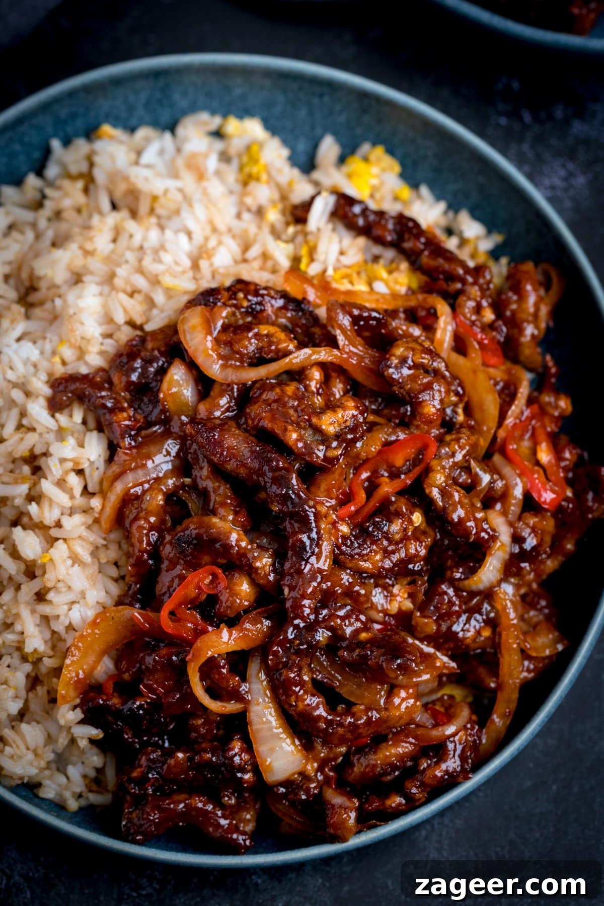 Crispy Chilli Beef Recipe with Sticky Sweet-Spicy Sauce 6 crispy chilli beef in a blue bowl with egg fried rice