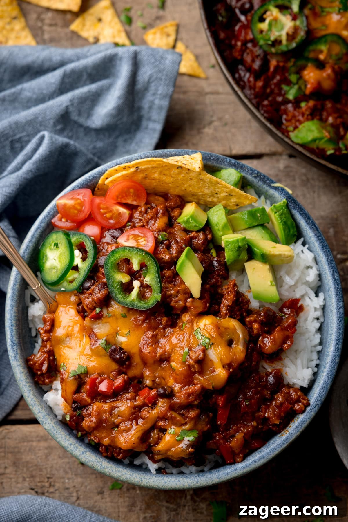 Tex‑Mex Minced Beef Recipe: Flavorful Beef for Tacos & Bowls 7 Tex-Mex minced beef on a bed of rice topped with cheese, jalapenos, coriander and avocados.