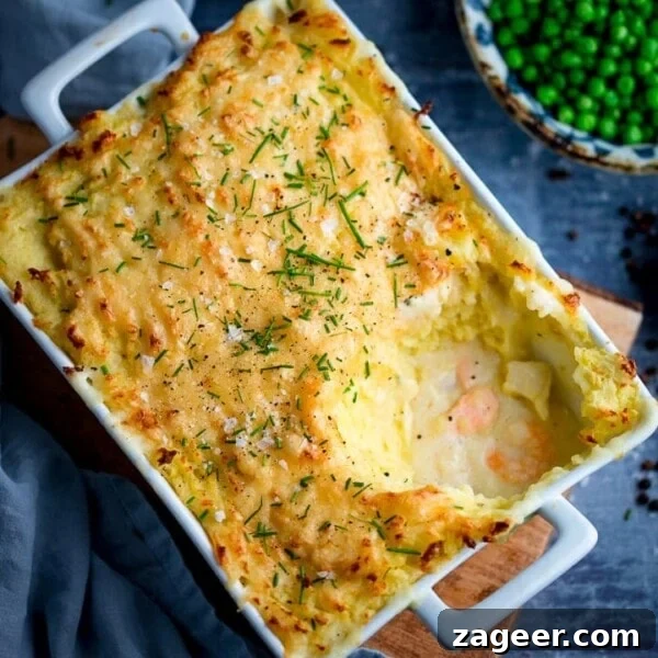 Crispy Beer-Battered Fish Recipe for Perfect Fried Fish 9 Fish pie with mashed potato in a white rectangular dish - scoop taken out