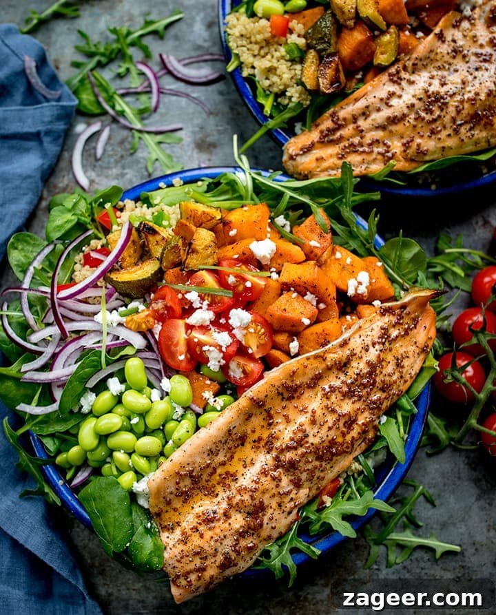 Honey Mustard Trout with Quinoa, Roasted Veggies & Feta 2 Blue bowl filled with roasted veg, tomatoes, edamame, red onion, courgette and topped with honey mustard trout.