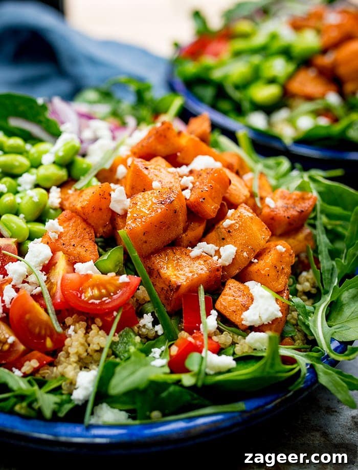 Honey Mustard Trout with Quinoa, Roasted Veggies & Feta 3 Close up of a bowl of salad with roasted sweet potato, edamame, tomato, quinoa and feta