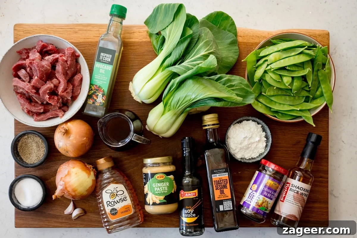 Quick and Flavorful Beef Stir-Fry with Garlic and Veggies 4 Ingredients for beef stir fry laid out on a board
