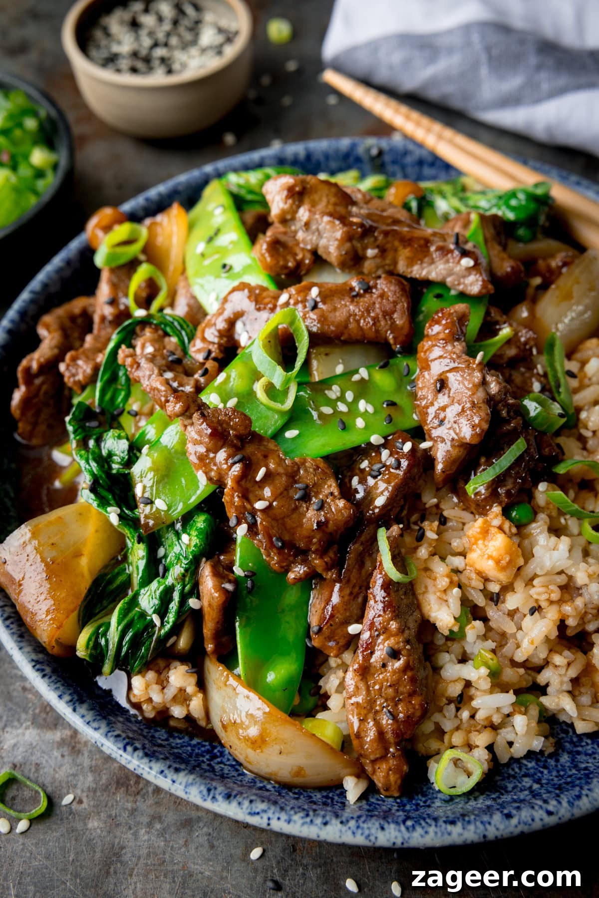 Quick and Flavorful Beef Stir-Fry with Garlic and Veggies 6 Beef stir fry served in a blue bowl with chopsticks