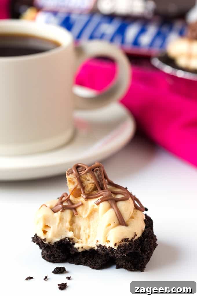 Snickers Cheesecake Bites Recipe: No-Bake Chocolate Peanut Bars 4 Mini Snickers Cheesecakes - with an Oreo base, peanut butter cheesecake and Snickers pieces. Totally addictive!