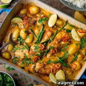 Comforting Chicken and Potato Curry Recipe for Weeknight Dinners 12 A square, overhead image of Chicken and Potato Curry. The Curry is in a large blue pan with a white inside lining.