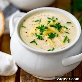 Creamy cauliflower soup topped with chives and cheese.
