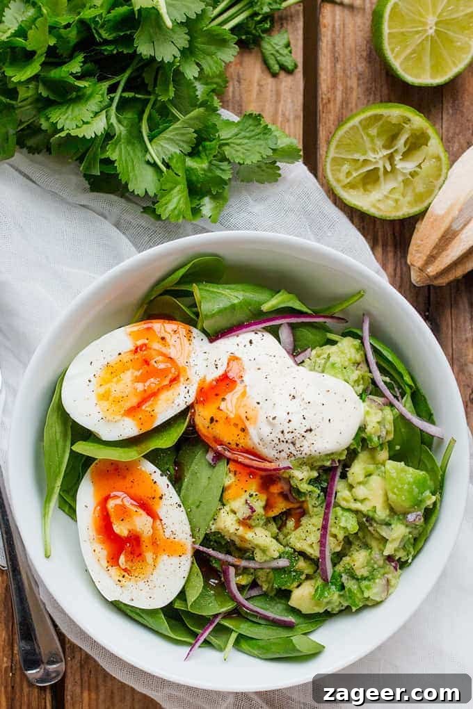 Creamy Avocado and Egg Breakfast Bowl with Salsa Verde 2 Overhead Photo of Guacamole and Egg Breakfast Bowl with Limes and Coriander in the background