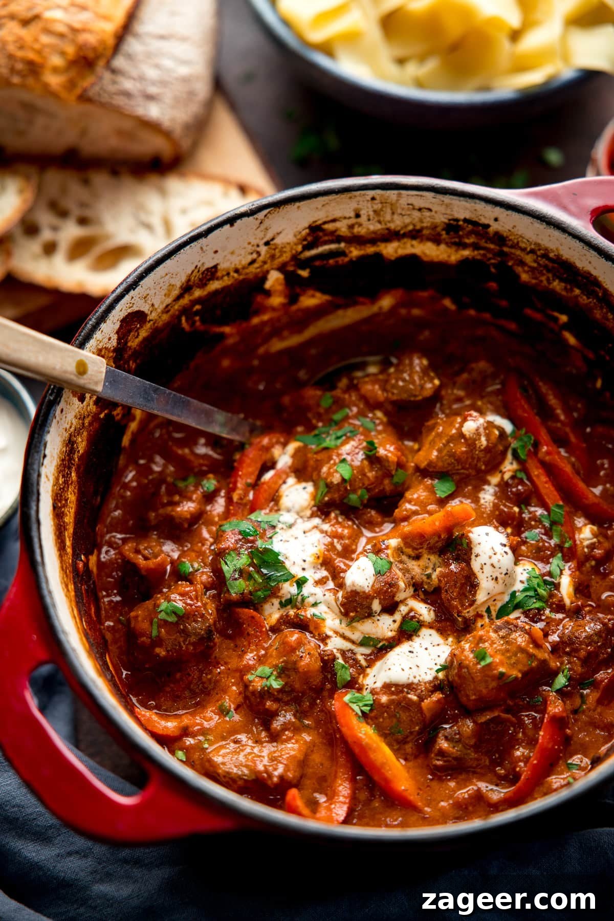 Authentic Hungarian Beef Goulash Recipe — Hearty Slow-Cooked Stew 2 Beef Goulash in a red dutch oven pan