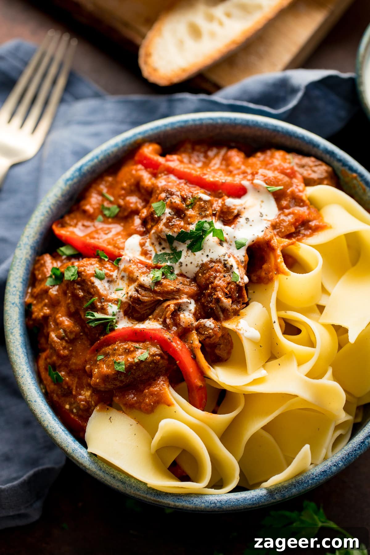 Authentic Hungarian Beef Goulash Recipe — Hearty Slow-Cooked Stew 6 Beef Goulash in a blue bowl with pappadelle pasta