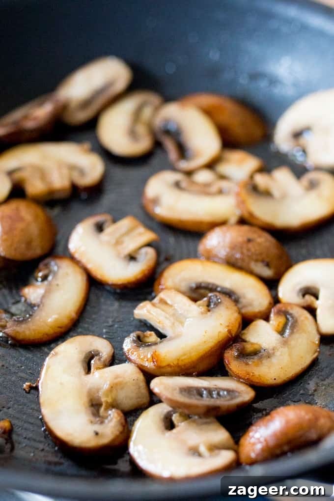 Garlic Mushroom and Brie Toast Recipe for Delicious Brunch 3 mushrooms cooking in a pan