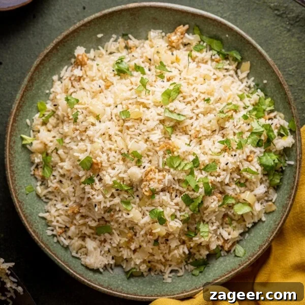 How to Make Perfect Thai Sticky Rice: Rice Cooker & Stovetop Methods 11 Onion Fried Rice on a green plate with a mustard coloured cloth in the bottom right hand corner.