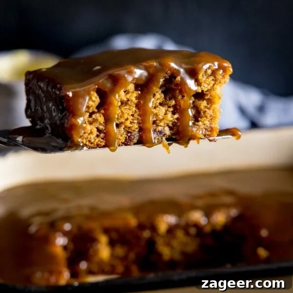 Raspberry White Chocolate Loaf Cake Recipe for Moist Dessert 6 Square image of a piece of sticky toffee pudding being lifted from a baking tin