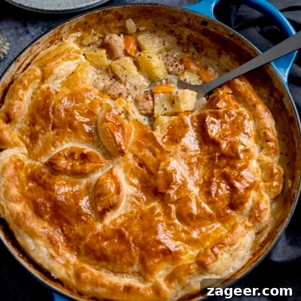 Savory Chicken and Ham Pie Recipe with Flaky Crust 9 Square image of a sausage and mustard pie - shot from overhead. There is a spoonful of the pie filling being taken out.