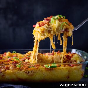 Make-Ahead Bacon Mashed Potato Casserole for Holiday Meals 12 A square image of Mashed Potato Casserole in a rectangular glass dish.