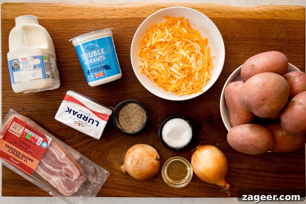 Make-Ahead Bacon Mashed Potato Casserole for Holiday Meals 3 A wide, overhead shot of the ingredients for Make-Ahead Mashed Potato Casserole with Bacon. The ingredients are laid out on a wooden cutting board, which is on top of a white marble surface. The ingredients are as follows: potatoes, butter, double cream, milk, salt, pepper, shredded cheese, oil, bacon, and onions.