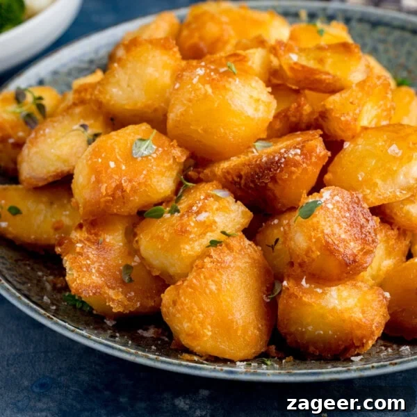 Make-Ahead Bacon Mashed Potato Casserole for Holiday Meals 10 A plate of crispy roast potatoes garnished with fresh herbs and a sprinkle of salt.