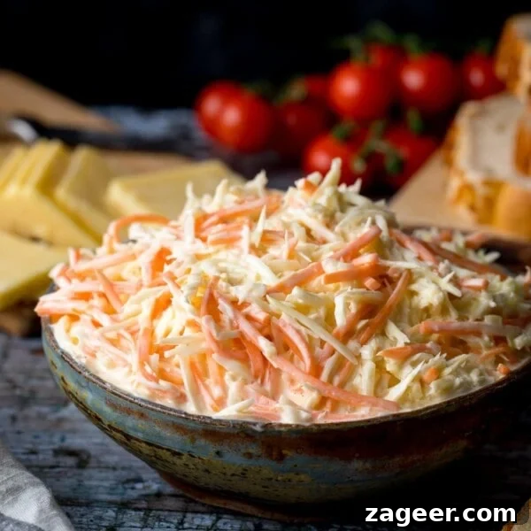 Crispy Lamb Salad with Lemon Mint Dressing 12 creamy coleslaw in a bowl. Cheese and cherry tomatoes in the background