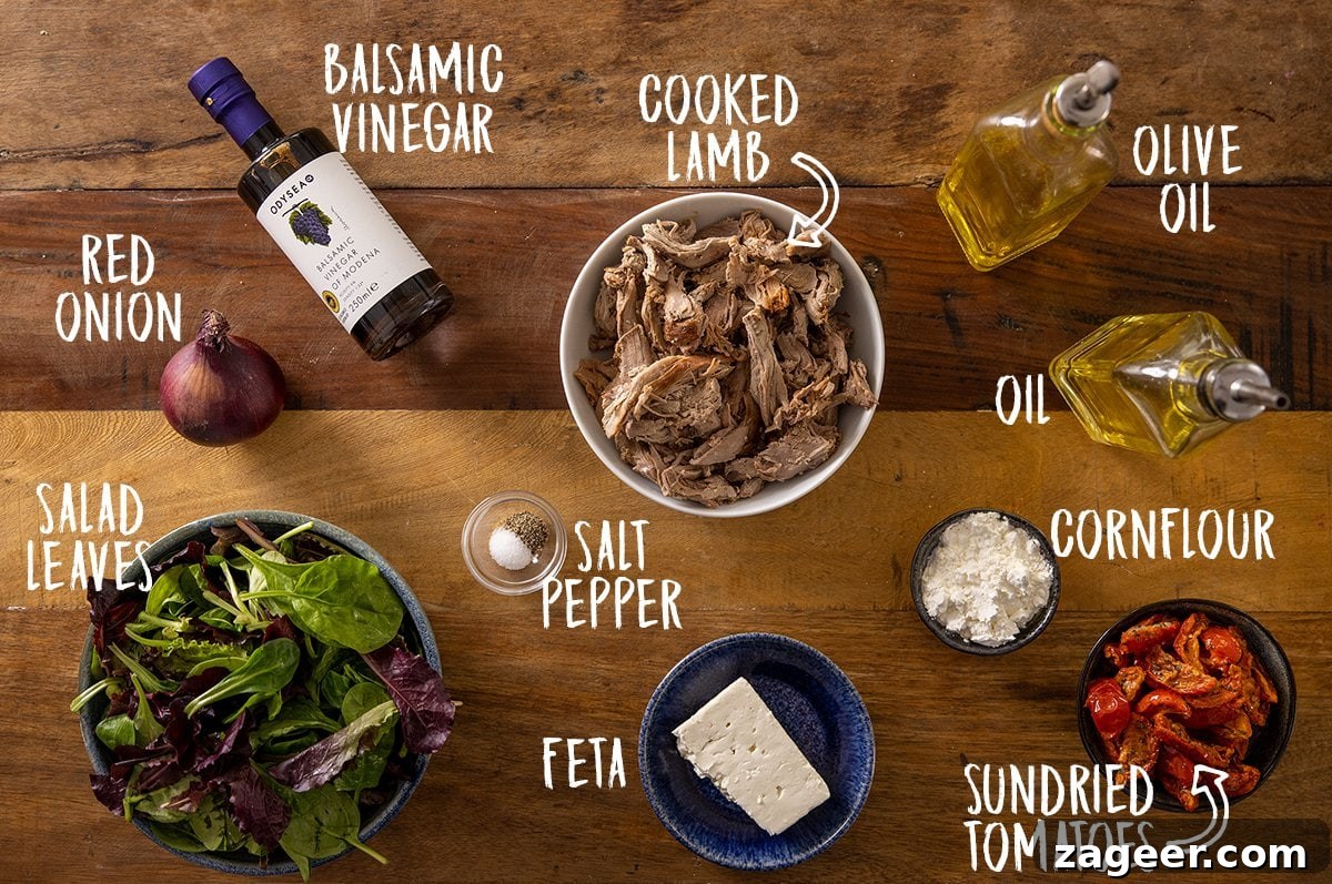 Crispy Lamb Salad with Lemon Mint Dressing 4 Overhead photo of ingredients for a lamb salad on a wooden table.