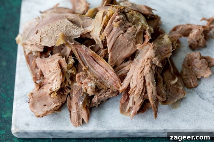 Crispy Lamb Salad with Lemon Mint Dressing 5 Shredded pieces of leftover roast lamb on a marble board