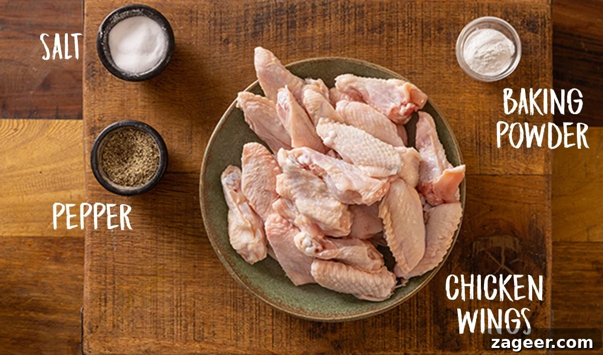Crispy Garlic Parmesan Chicken Wings Recipe 3 Ingredients for air fryer chicken wings on a wooden board.