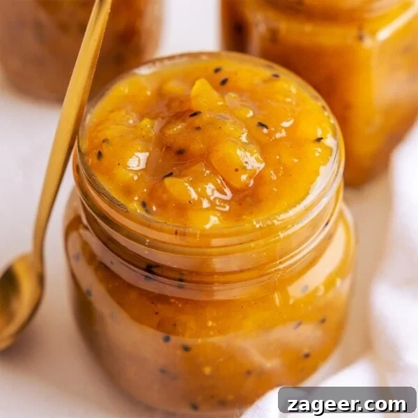 Creamy Coconut Curry Sauce Recipe for Authentic Flavor 6 A jar full to the brim of mango chutney with a brass coloured spoon leaning up against the jar.