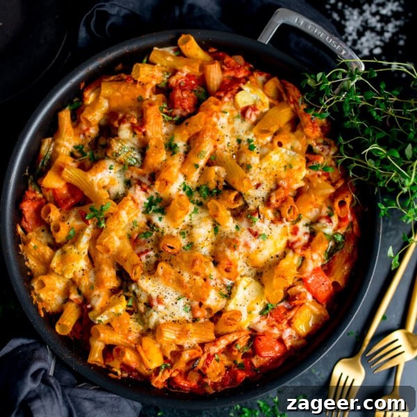 Creamy Tuna Pasta Bake with Cheesy Golden Crust 10 Baked rigatoni pasta with melted cheese, tomato sauce, turkey and ham in a black dish