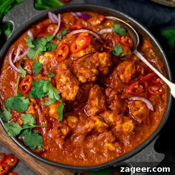 Authentic Tandoori Chicken Recipe: Flavorful Indian Grill Instructions 16 chicken madras in a serving bowl topped with chilles and coriander