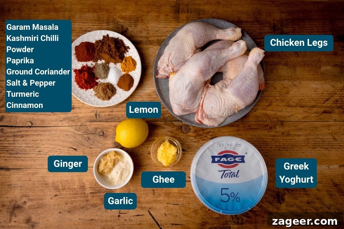 Authentic Tandoori Chicken Recipe: Flavorful Indian Grill Instructions 4 Chicken legs, Greek yoghurt, ghee, garlic, ginger, lemon, and assorted spices including garam masala, chilli powder, paprika, coriander, salt, pepper, turmeric and cinnamon on a wooden surface.