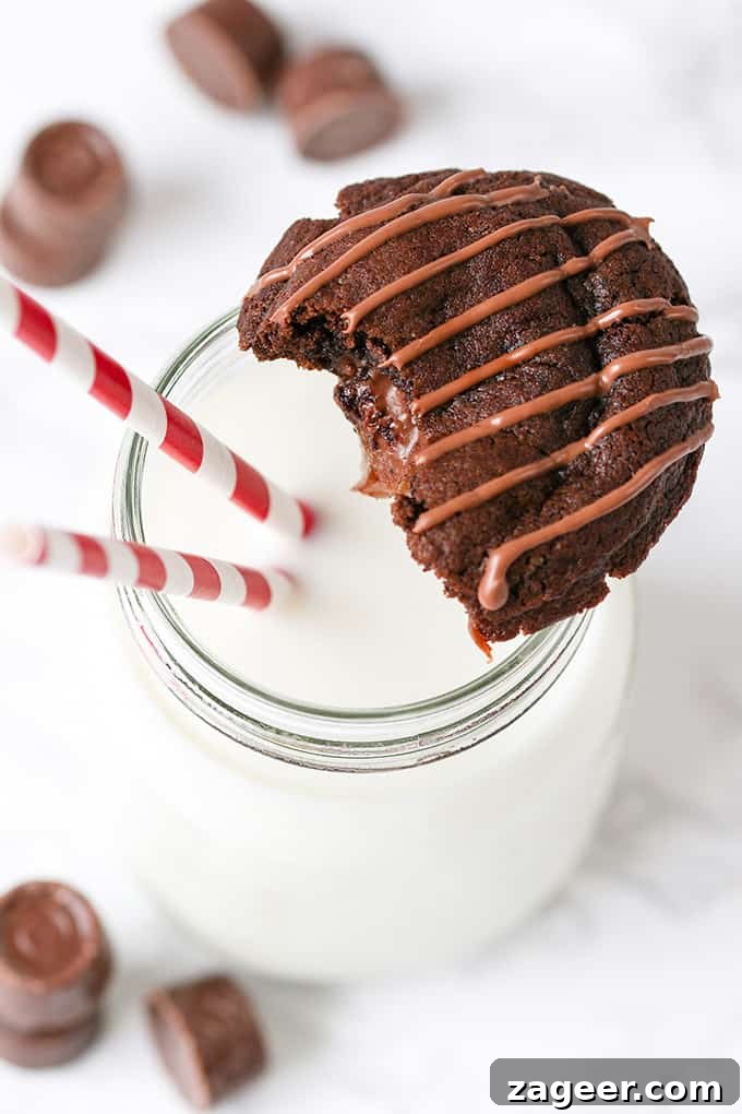 Gooey Rolo-Stuffed Chocolate Chip Cookies 2 Gooey Rolo Stuffed Cookies with a glass of milk.