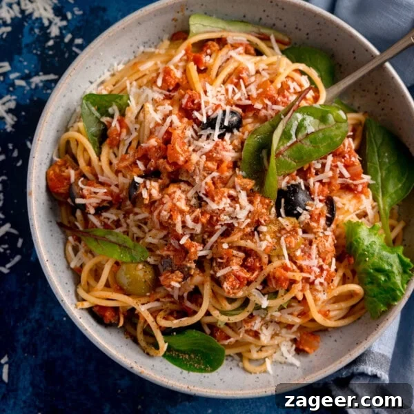 Lemon-Feta Baked Fish Recipe for Flaky, Flavorful Fillets 12 A bowl of tuna spaghetti with tomato sauce, black olives, and leafy greens, topped with grated cheese.