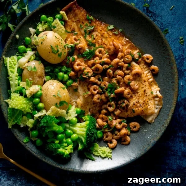 Lemon-Feta Baked Fish Recipe for Flaky, Flavorful Fillets 9 A square shot of a bowl of Plaice with Brown Butter Shrimp served with sides.