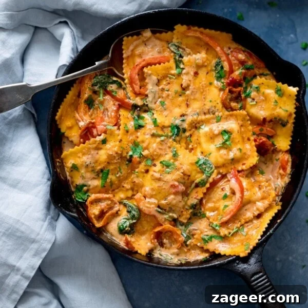Red Pepper and Lentil Sauce Recipe for Pasta and Veggies 9 Ravioli in creamy tomato sauce in a black pan.