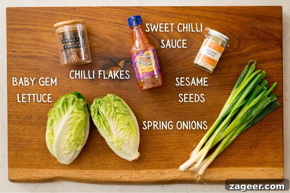 Turkey Lettuce Wrap Recipe: Flavorful Low-Carb Meal Ideas 4 A wooden board with baby gem lettuce, spring onions, a bottle of sweet chilli sauce, a jar of chilli flakes, and a jar of sesame seeds.